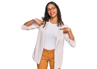 Young african american girl wearing business clothes looking confident with smile on face, pointing...