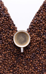 Espresso cup with coffee beans on a white background with copy space