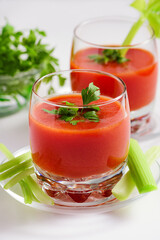 Tomato juice in glass with celery