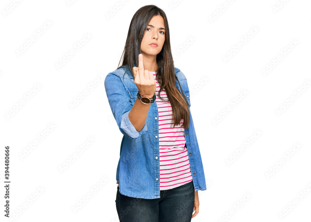 Sticker Young brunette woman wearing casual clothes showing middle finger, impolite and rude fuck off expression