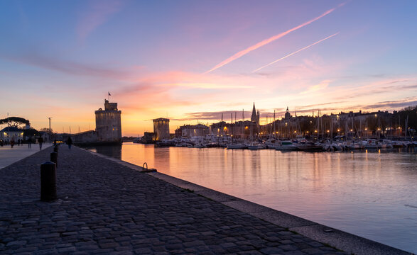 Panoramic view of the old harbor of La Rochelle at sunset with its famous old towers