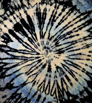 Spiral tie dye texture. Hippie tie-dye wallpaper. Boho festival tiedye background in tan gray.
