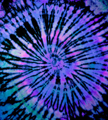 Spiral tie dye texture. Hippie tie-dye wallpaper. Boho festival tiedye background in purple. - 394483231