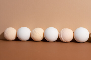 The homemade organic bath bombs on beige background. Spa concept. Presents for body. Space for text.
