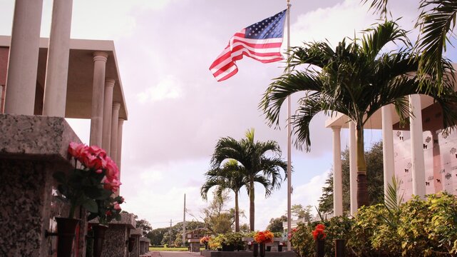 American Flag in a cemetery on a windy day