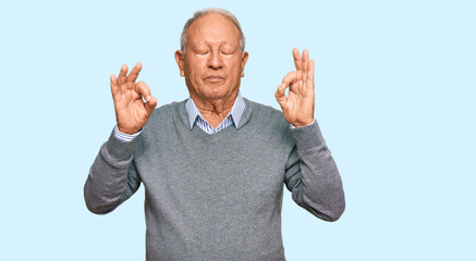 Senior caucasian man wearing casual clothes relax and smiling with eyes closed doing meditation gesture with fingers. yoga concept.