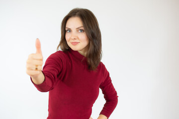 Happy young woman giving thumb up on white background