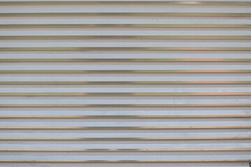 Rolling shutter door. Roller garage metal gate. Electric roll white window background shutter.