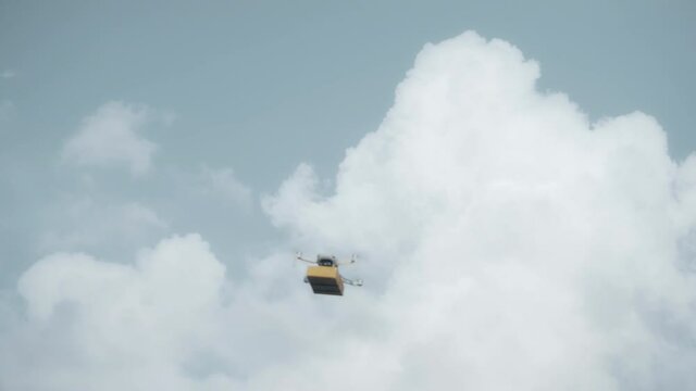 flying on a sky delivery drone with holding a .cardboard parcel