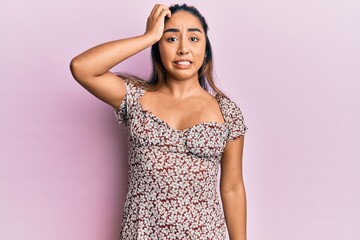 Young latin woman wearing casual clothes confuse and wonder about question. uncertain with doubt,...