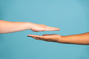 Hands of Caucasian and African young women with white and dark skin