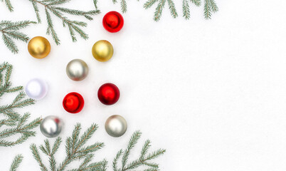 Christmas composition. Fir branches and christmas balls in the snow. Flat lay, copy space.