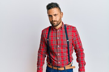 Fototapeta premium Handsome man with beard wearing hipster elegant look skeptic and nervous, frowning upset because of problem. negative person.