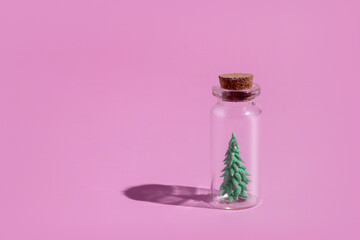 Miniature glass bottle with a Christmas tree under the cork: a minimalistic concept for the New Year holidays