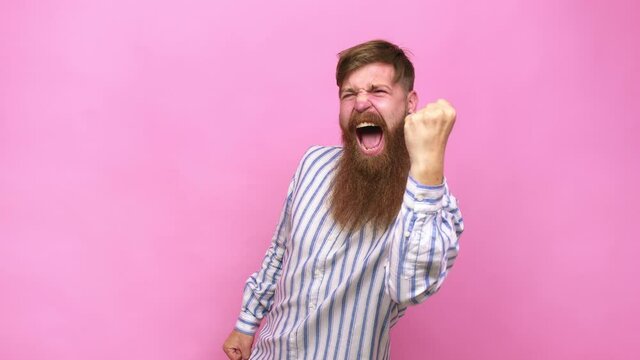 Young adult bearded caucasian man isolated showing fist to camera, aggressive facial expression