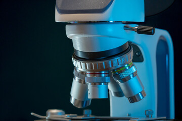 Microscope in laboratory at night. Microbiology and research concept.