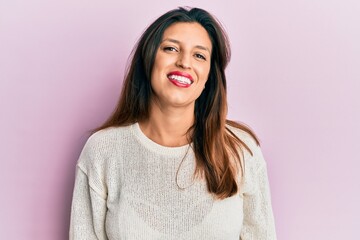 Fototapeta premium Beautiful hispanic woman wearing casual clothes smiling with an idea or question pointing finger up with happy face, number one