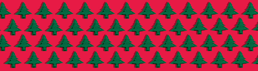 Minimal composition made of Christmas felt kraft tree decoration on red background. Christmas isometric pattern, long banner. Top view. Holiday New Year concept.