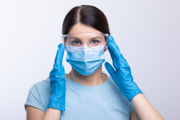 Nurse or doctor wearing and checking protective equipment against viruses and bacterial disease