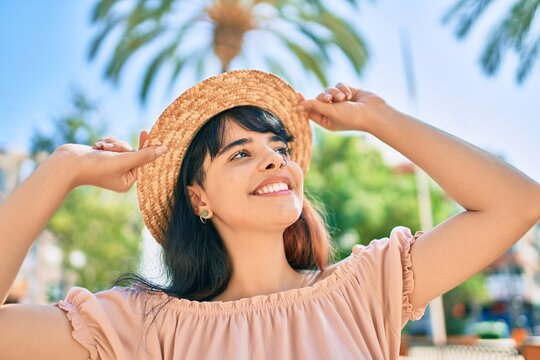 Young hispanic tourist girl wearing summer style walking at the park.