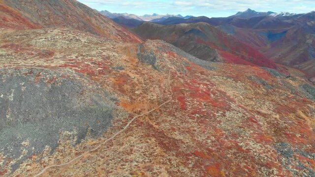 Drone aerial video footage of Tombstone Territorial Park in northern Canada, arctic area with snow capped mountains in fall, autumn season on Dempster Highway 