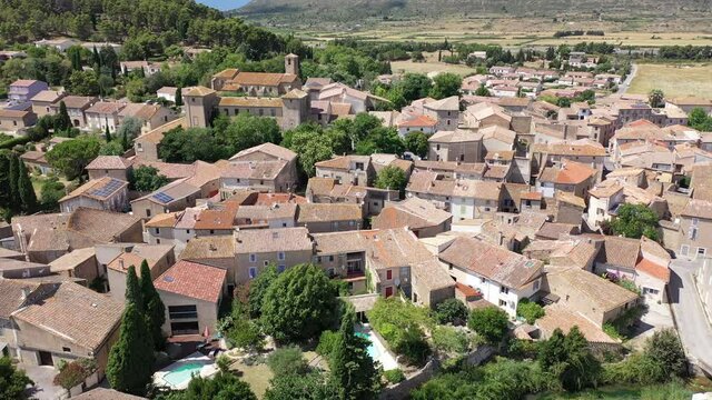 Scenic aerial view of French township of Fontcouverte at foot of Alaric mountain on sunny summer day, Aude, Occitanie