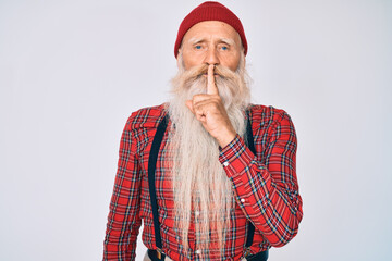 Old senior man with grey hair and long beard wearing hipster look with wool cap asking to be quiet...