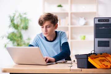 Boy reparing computers at workshop