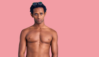 Fototapeta premium African handsome man wearing swimsuit and sunglasses depressed and worry for distress, crying angry and afraid. sad expression.