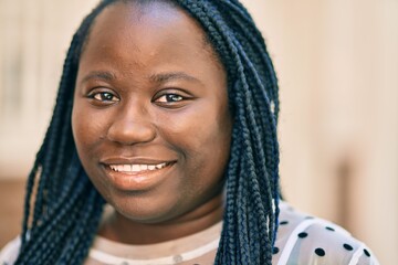 Young african american woman smiling happy standing at the city.