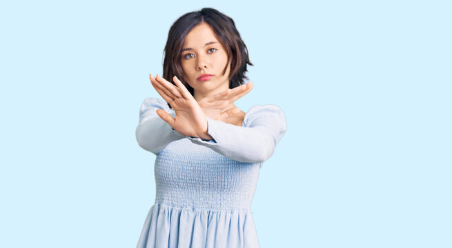 Young beautiful girl wearing casual clothes rejection expression crossing arms and palms doing negative sign, angry face