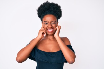 Young african american woman wearing casual clothes covering ears with fingers with annoyed expression for the noise of loud music. deaf concept.