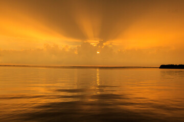 Fototapeta na wymiar Golden sunrays at sunset over the Bay