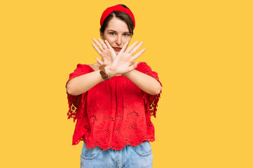 Young brunette woman with short hair wearing casual summer clothes and diadem rejection expression crossing arms doing negative sign, angry face
