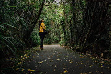 Woman walking on a trail among the rainforest