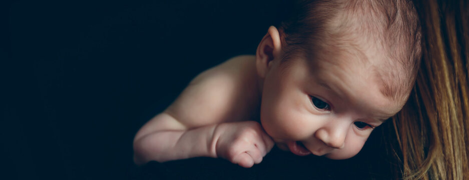 Close-up Of Cute Baby Girl On Black Background