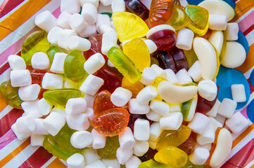 Mixed marshmallow candies with sugar, banana jelly candies, background with sweets, marshmallow figure, jelly rings