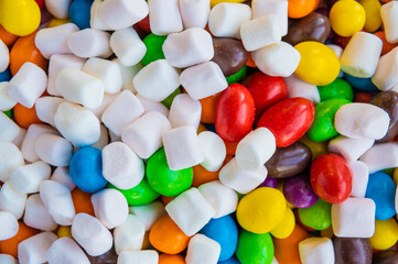 Mix of colorful Candies, delights and marshmallow on the plate. The sugar feast, any celebrations or children's party.