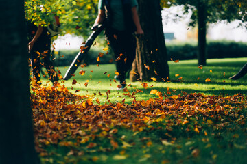 A woman operating a heavy duty leaf blower.