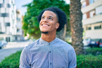 Young african american man smiling happy walking at the city.