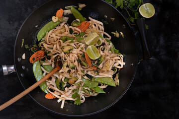 Vegan vegetables pad thai in wok, copy space