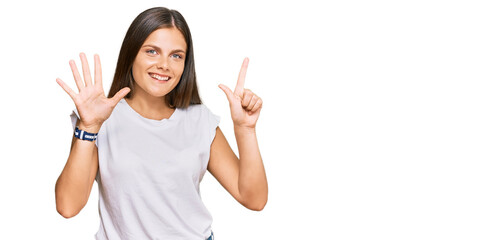 Young caucasian woman wearing casual white tshirt showing and pointing up with fingers number seven while smiling confident and happy.