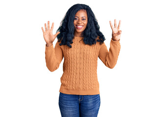 Beautiful african american woman wearing casual  sweater showing and pointing up with fingers number eight while smiling confident and happy.