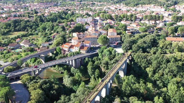 General view from drone of Ceret town on banks of river Tech in foothills of Pyrenees mountains in summer, France