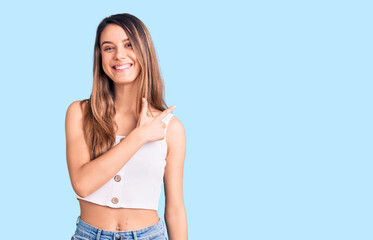 Fototapeta premium Young beautiful girl wearing casual sleeveless t shirt cheerful with a smile of face pointing with hand and finger up to the side with happy and natural expression on face