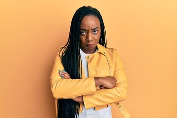 Young african american woman wearing casual jacket skeptic and nervous, disapproving expression on...