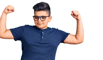 Little boy kid wearing casual clothes and glasses showing arms muscles smiling proud. fitness concept.