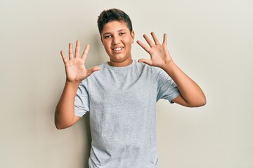 Fototapeta premium Hispanic teenager boy wearing casual clothes with hand on stomach because nausea, painful disease feeling unwell. ache concept.