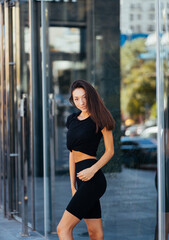 Beautiful woman, summer in city, fitness training on street.