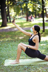 Young sport girl take selfie on a smartphone outdoors on nature.